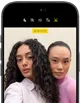 iPhone 18 Pro, black, front exterior, displaying two models posing for the camera, demonstrating the Center Stage front camera