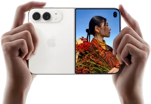 iPhone Duo, Star White colour, held by two hands in horizontal orientation, unfolded, left panel shows 48MP Dual Fusion rear cameras, right panel shows person getting their picture taken on outer display, the subject of the photo is able to see their face as their picture is getting taken using Duo Preview