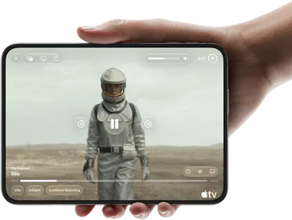iPhone Duo, held with one hand, opened in horizontal orientation, fully unfolded, interior screen displays Apple TV show “Silo”