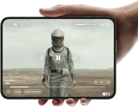iPhone Duo, held with one hand, opened in horizontal orientation, fully unfolded, interior screen displays Apple TV show “Silo”