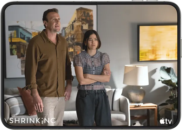 iPhone Duo, opened in horizontal position, Apple TV show “Shrinking” plays on screen