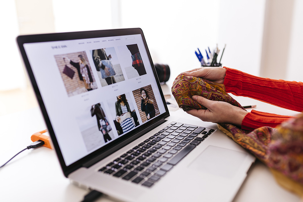 Spain, tarragona. Young designers checking new fabrics, while making changes to their website.